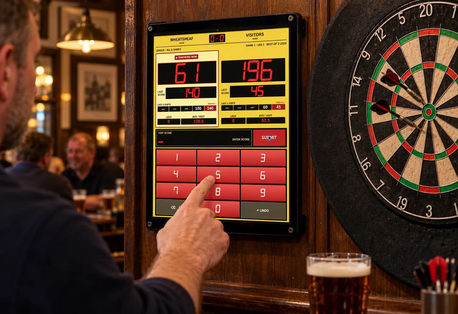 A pub marker using Retro Darts Scorer on a wall-mounted tablet